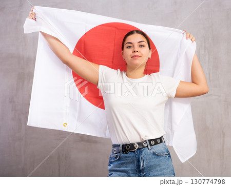 Positive girl with Japan flag rooting for your favorite team Positive girl with Japan flag rooting for your favorite team 130774798
