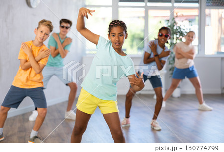 Dark-skinned tween girl krumper posing during workout in dance class Dark-skinned tween girl krumper posing during workout in dance class 130774799