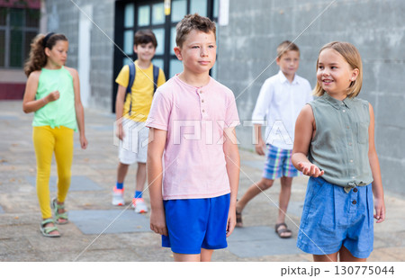Young girl and boy walking together Young girl and boy walking together 130775044