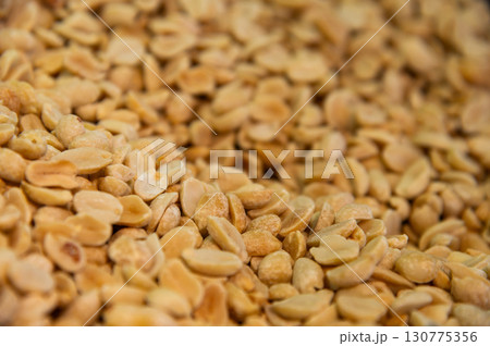 Lots of roasted peanuts as background, top view. Macro shot of peeled peanuts in large volume Lots of roasted peanuts as background, top view. Macro shot of peeled peanuts in large volume 130775356