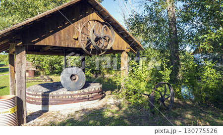 Antique shredder, branch crusher under a wooden roof in Slovakia. 130775526
