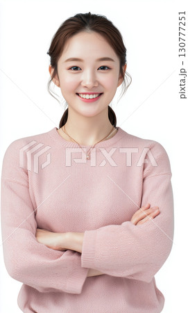 Korean woman with a cheerful smile posing confidently with arms crossed in a simple pastel sweater Korean woman with a cheerful smile posing confidently with arms crossed in a simple pastel sweater 130777251