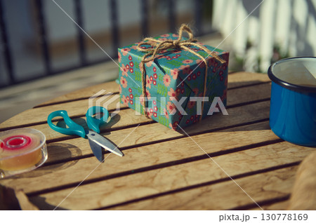 Gift Wrapping Scene with Scissors and Floral Present 130778169