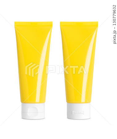 Yellow plastic cosmetic tubes with white flip caps, front and back view on white background, clean packaging mockup 130779632