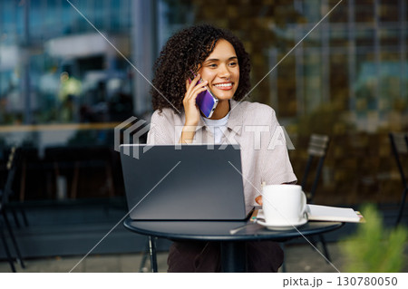 Professional Woman Working Remotely at a Caf Professional Woman Working Remotely at a Caf 130780050