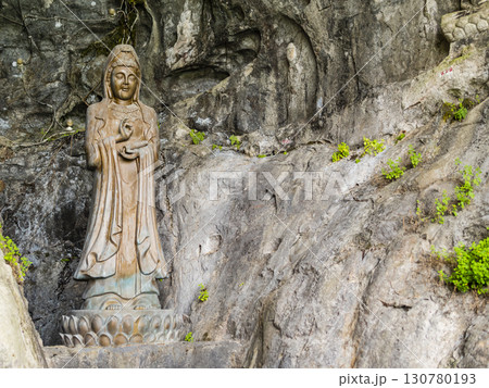 Impressive stone Buddha statues carved at the entrance of Fubo Hill cave, Guilin, China 130780193