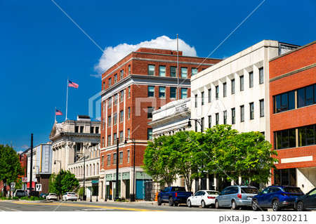 View of Pittsfield's historic downtown in Massachusetts, featuring brick and stone commercial buildings lining tree-framed North street 130780211