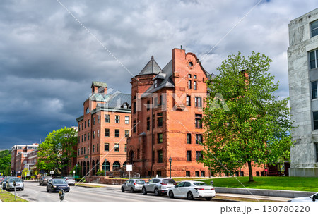 Historic Richardsonian Romanesque building with conical tower and arched entry on State Street near the Vermont State House in Montpelier, United States 130780220