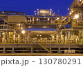 Night view of the equipment of a gas field with a large number of pipes. 130780291