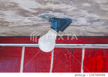Old Light Bulb Hanging From Damaged Ceiling Xian Guang Village Taiwan. 130780406