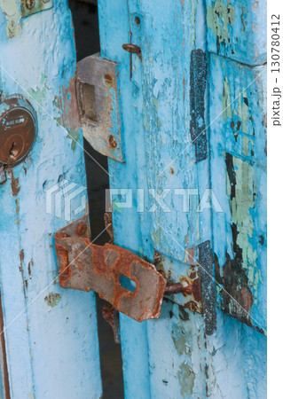 Rusty Lock on Peeling Blue Door at Xian Guang Military Kindred Village. Rusty Lock on Peeling Blue Door at Xian Guang Military Kindred Village. 130780412