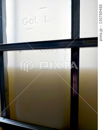 Industrial Container Filled With Liquid Located in a Storage Area During Daylight Hours 130780488