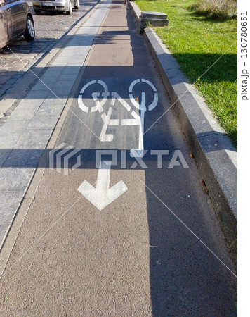 Bike Cycle Path Signs Showing Direction for Cyclists in a Vibrant Urban Setting on a Sunny Day 130780651