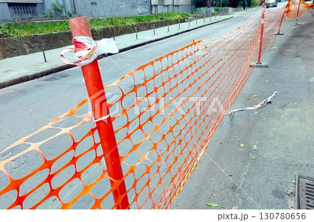 Road Under Construction With Protective Guardrails Guiding Traffic Along the Bustling Urban Pathway 130780656