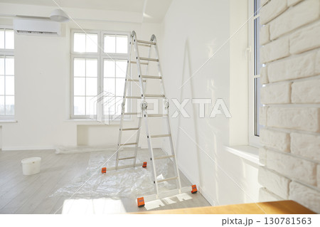 Newly renovated house or apartment with freshly painted walls, new windows, and step ladder Newly renovated house or apartment with freshly painted walls, new windows, and step ladder 130781563