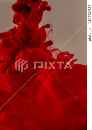 Red ink swirling in water creating abstract patterns Red ink swirling in water creating abstract patterns 130782437