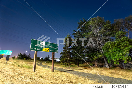 A U.S. Route 101 freeway sign near San Francisco International Airport (SFO) in California, USA. The illuminated sign gives directions to San Francisco and San Jose 130785414