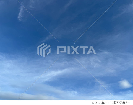 Blue sky with scattered white clouds in natural daylight Blue sky with scattered white clouds in natural daylight 130785673