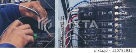 Banner Electrical mechanic technician check wire electric cabinet. Inspector men hands working maintenance service. Electrician circuit repair operation. Men hands fix breaker with copy space 130785933