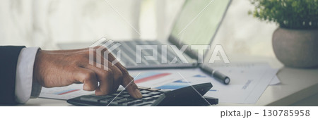 Banner Asian Business man hands using calculator counting tax financial bill. Tax audit Finacial concept. Panorama Close up businessman hands calculating number tax audit planning with copy space Banner Asian Business man hands using calculator counting tax financial bill. Tax audit Finacial concept. Panorama Close up businessman hands calculating number tax audit planning with copy space 130785958