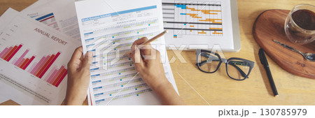 Banner woman working office desk reading financial report finance chart graph on table. Wide tax audit woman hands working paperwork office. Banner Businesswoman Audit financial with copy space Banner woman working office desk reading financial report finance chart graph on table. Wide tax audit woman hands working paperwork office. Banner Businesswoman Audit financial with copy space 130785979