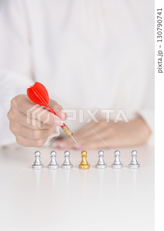 Hand point dart to golden chess pawn pieces or leader businessman stand out of crowd people of silver men. leadership, business, team, teamwork, unique and Human resource management concept Hand point dart to golden chess pawn pieces or leader businessman stand out of crowd people of silver men. leadership, business, team, teamwork, unique and Human resource management concept 130790741