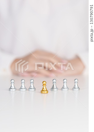 golden chess pawn pieces or leader businessman stand out of crowd people of silver men. leadership, business, team, teamwork and Human resource management concept golden chess pawn pieces or leader businessman stand out of crowd people of silver men. leadership, business, team, teamwork and Human resource management concept 130790791