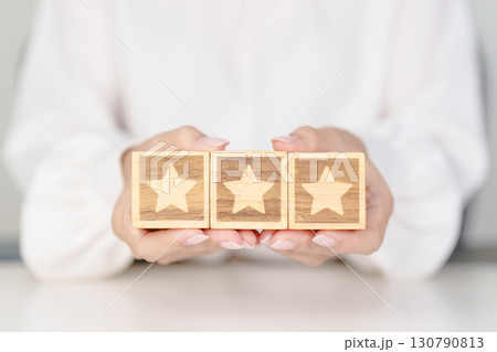 hand show Star block. Customer choose rating for user reviews. Service rating, ranking, customer review, satisfaction, evaluation and feedback concept hand show Star block. Customer choose rating for user reviews. Service rating, ranking, customer review, satisfaction, evaluation and feedback concept 130790813