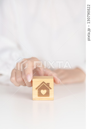 Hand Holding Home with Heart block. Property investment, House Mortgage, Real Estate tax, homeless, donation, Financial and happy family concepts 130790822