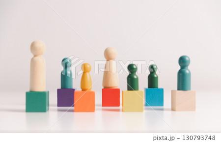 Concept of diversity, inclusion, equality is highlighted in team setup, wooden elements, symbolizing leadership, authority, influence, strong communication skills, inclusive organizational structure. Concept of diversity, inclusion, equality is highlighted in team setup, wooden elements, symbolizing leadership, authority, influence, strong communication skills, inclusive organizational structure. 130793748