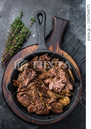 Beef bourguignon stew with tender beef in a pan. black background. top view Beef bourguignon stew with tender beef in a pan. black background. top view 130794075