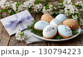 Easter eggs cookies with gift box and spring flowers on wooden table 130794223
