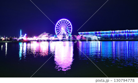 Szczecin, Poland. 16 July 2025. Ferris wheel on the river at night 130794778