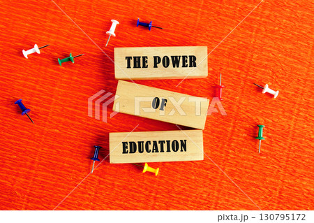 Business and Words Matter concept. Copy space. THE POWER OF EDUCATION assembled from wooden blocks in a composition with stationery pins on an orange provocative background, top view Business and Words Matter concept. Copy space. THE POWER OF EDUCATION assembled from wooden blocks in a composition with stationery pins on an orange provocative background, top view 130795172