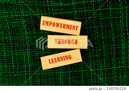 The message connect through learning. EMPOWERMENT THROUGH LEARNING made of wooden blocks on fabric background, top view The message connect through learning. EMPOWERMENT THROUGH LEARNING made of wooden blocks on fabric background, top view 130795229