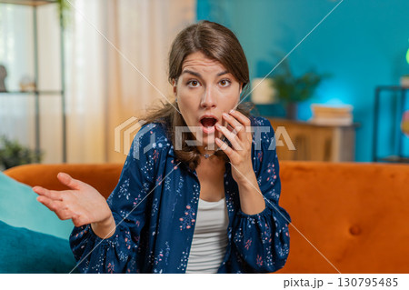 Portrait of upset Caucasian young woman making face, feeling bored, disappointed in result, bad news 130795485