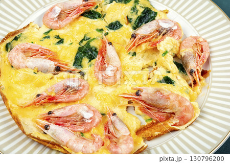 Appetizing omelette with seafood and greens. 130796200
