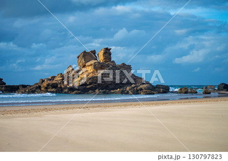 View of idyllic nature landscape with rocky cliff shore and waves crashing on. Rocks near Sagres. West Atlantic coast of Algarve region, south of Portugal. 130797823