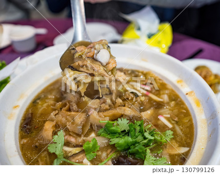 Close-Up of a Traditional Chinese Hot and Sour Soup Garnished with Fresh Cilantro Close-Up of a Traditional Chinese Hot and Sour Soup Garnished with Fresh Cilantro 130799126