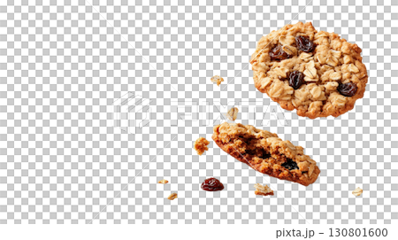 Freshly baked crumbly oatmeal raisin cookies falling on a white background with scattered crumbs and a rustic homemade appearance 130801600