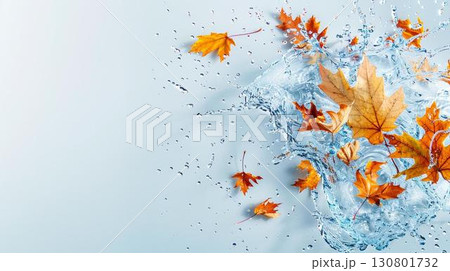 Autumn leaves splashing in water on a blue background. 130801732