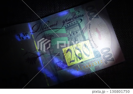 Inspecting Ukrainian Hryvnias Under Ultraviolet Light to Reveal Hidden Security Features Inspecting Ukrainian Hryvnias Under Ultraviolet Light to Reveal Hidden Security Features 130801750