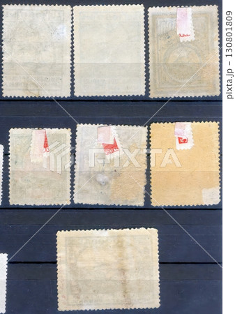 Exploring the Reverse Sides of Vintage Postage Stamps in a Philatelic Collection Exploring the Reverse Sides of Vintage Postage Stamps in a Philatelic Collection 130801809