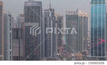 Residential and office buildings in Jumeirah lake towers district day to night timelapse in Dubai Residential and office buildings in Jumeirah lake towers district day to night timelapse in Dubai 130802698