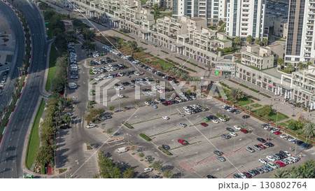 Aerial view full cars at large outdoor parking lots timelapse in Dubai, UAE. Aerial view full cars at large outdoor parking lots timelapse in Dubai, UAE. 130802764