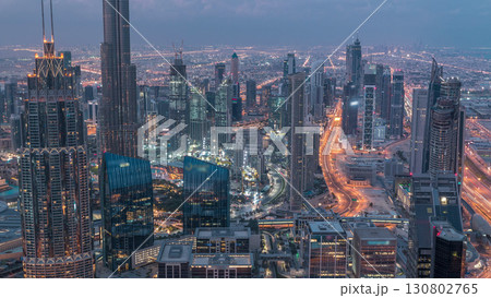 Dubai Downtown skyline futuristic cityscape with many skyscrapers and Burj Khalifa aerial night to day timelapse. 130802765