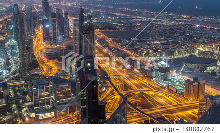 Dubai Downtown skyline futuristic cityscape with many skyscrapers and Burj Khalifa aerial night to day timelapse. Dubai Downtown skyline futuristic cityscape with many skyscrapers and Burj Khalifa aerial night to day timelapse. 130802767