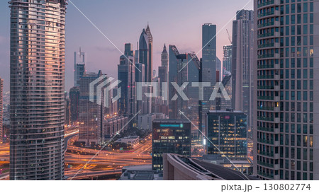 Aerial view of new skyscrapers and tall buildings in Dubai night to day timelapse Aerial view of new skyscrapers and tall buildings in Dubai night to day timelapse 130802774