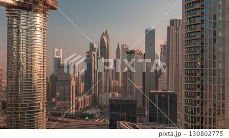 Dubai International Financial Centre district with modern skyscrapers timelapse at sunrise Dubai International Financial Centre district with modern skyscrapers timelapse at sunrise 130802775