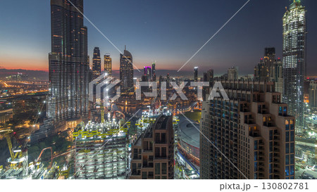 Panoramic skyline view of Dubai downtown before sunrise with mall, fountains and skyscrapers aerial night to day timelapse Panoramic skyline view of Dubai downtown before sunrise with mall, fountains and skyscrapers aerial night to day timelapse 130802781